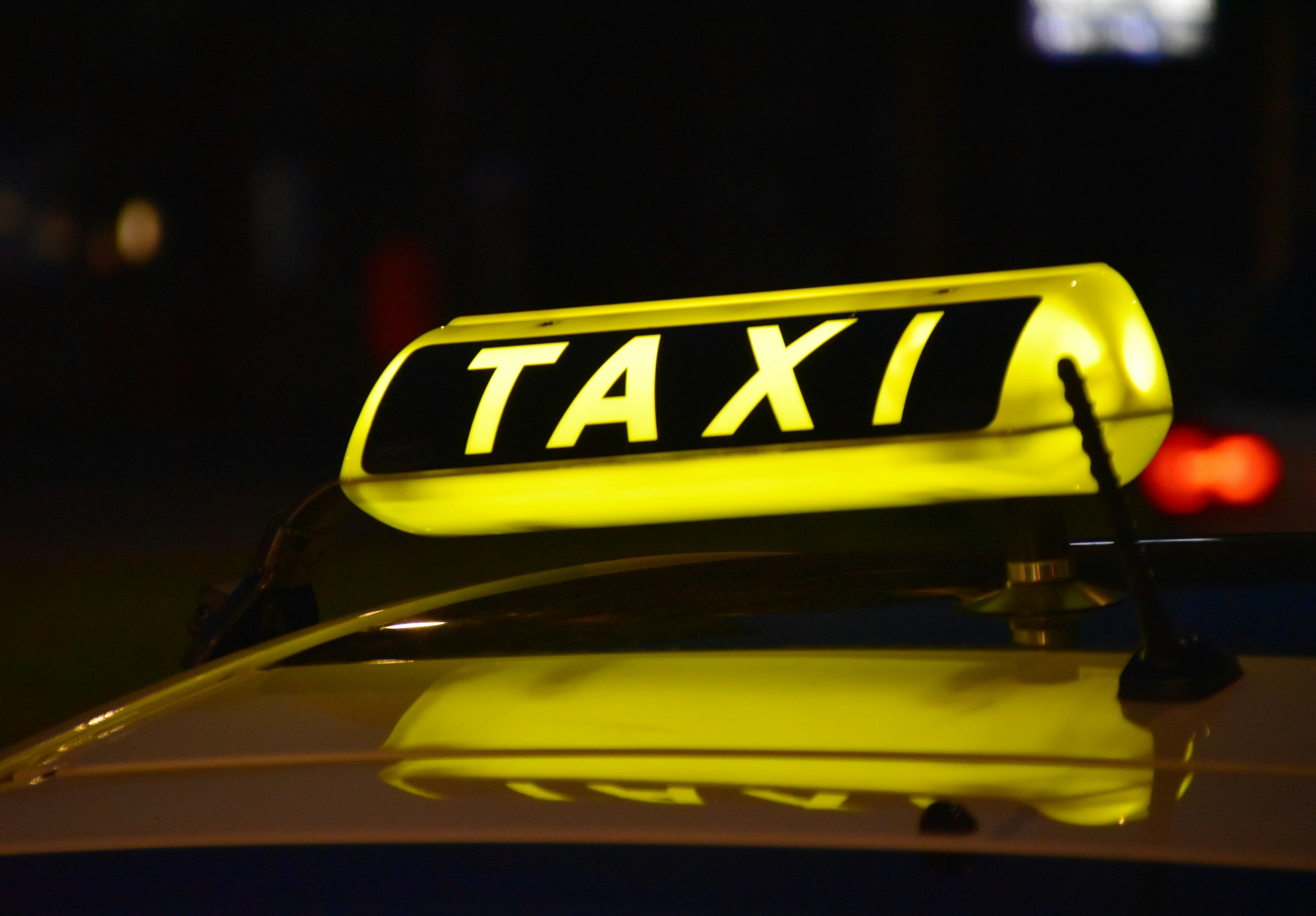 Illuminated taxi sign at night